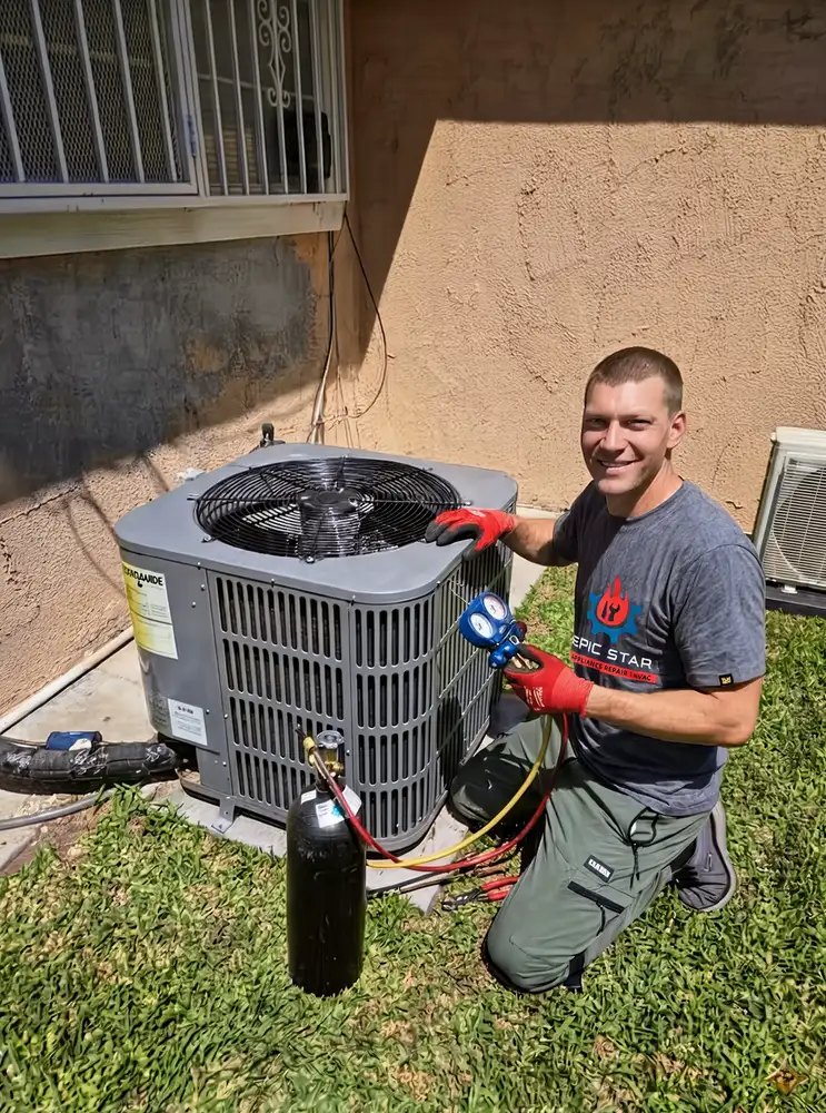 Epic Star owner-technician kneeling beside a residential outdoor AC condenser unit performing an AC tune-up with refrigerant gauges in Westwood, CA