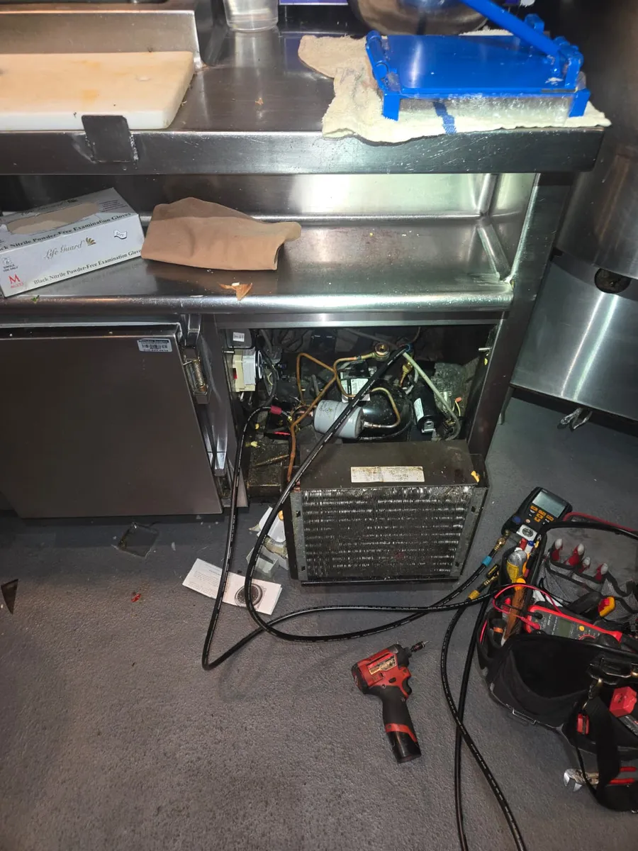 Under-counter commercial refrigerator with compressor unit pulled out for service by Epic Star in West Hollywood, CA